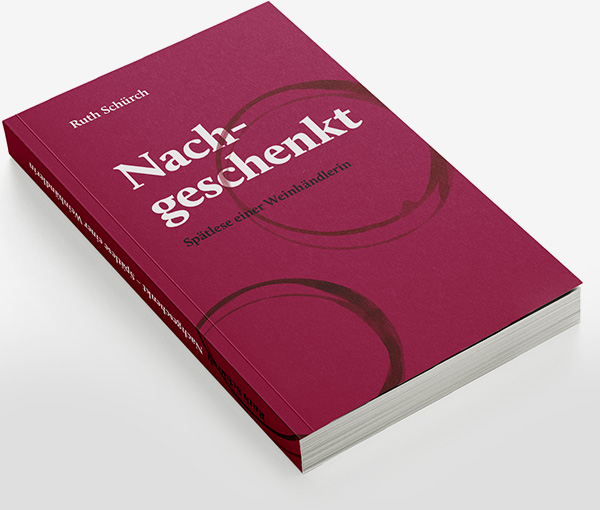 Buch "Ruth Schürch: Nachgeschenkt – Spätlese einer Weinhändlerin" Roter Buchumschlag mit gedruchten Weinring-Flecken